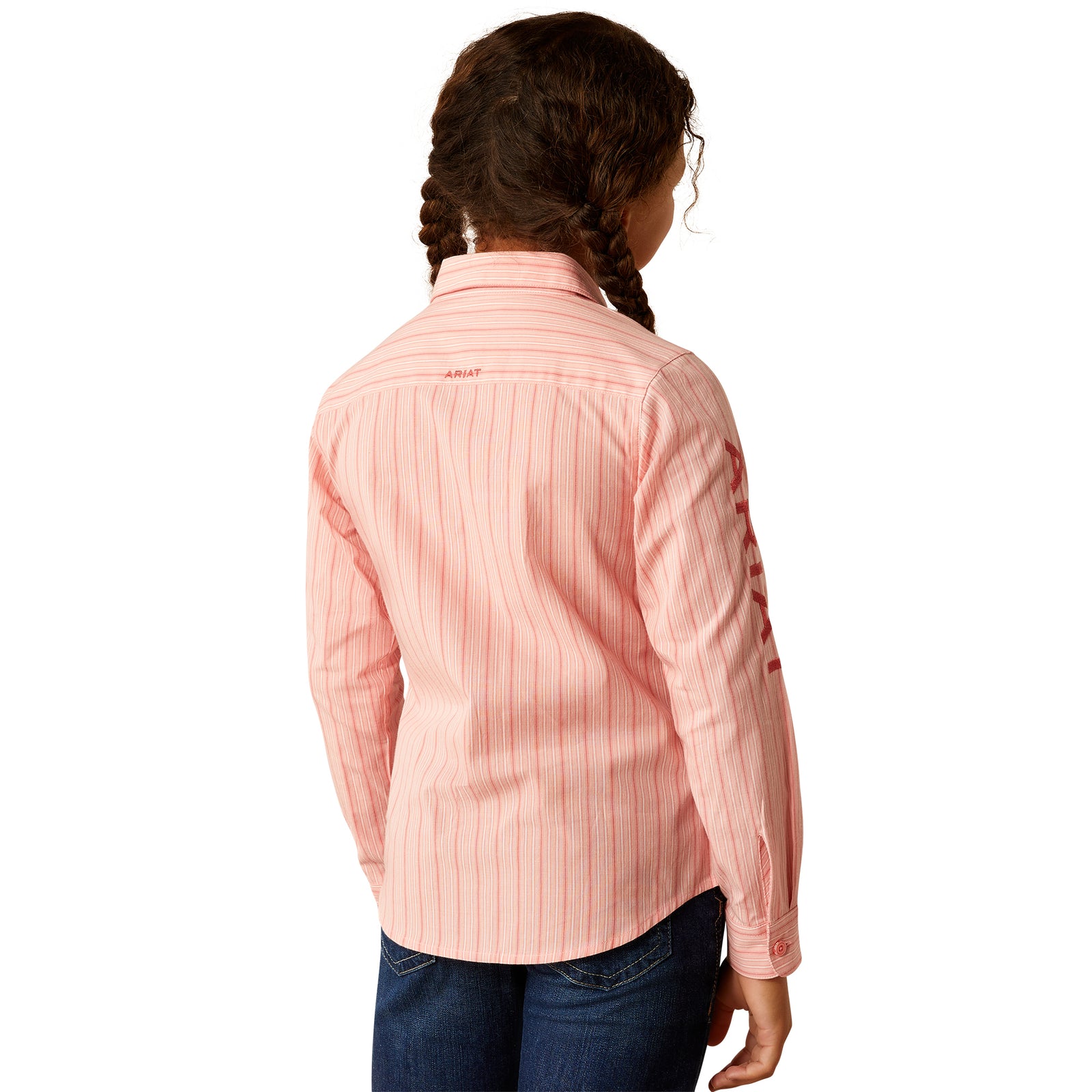 Ariat Girl's Team Kirby L/S Western Shirt. Young girl wearing a pink striped shirt with 'Ariat' branding on a white background