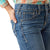 Ariat Girl's Lilla Boot Cut Jeans. Close-up of blue jeans with a person wearing a plaid shirt.