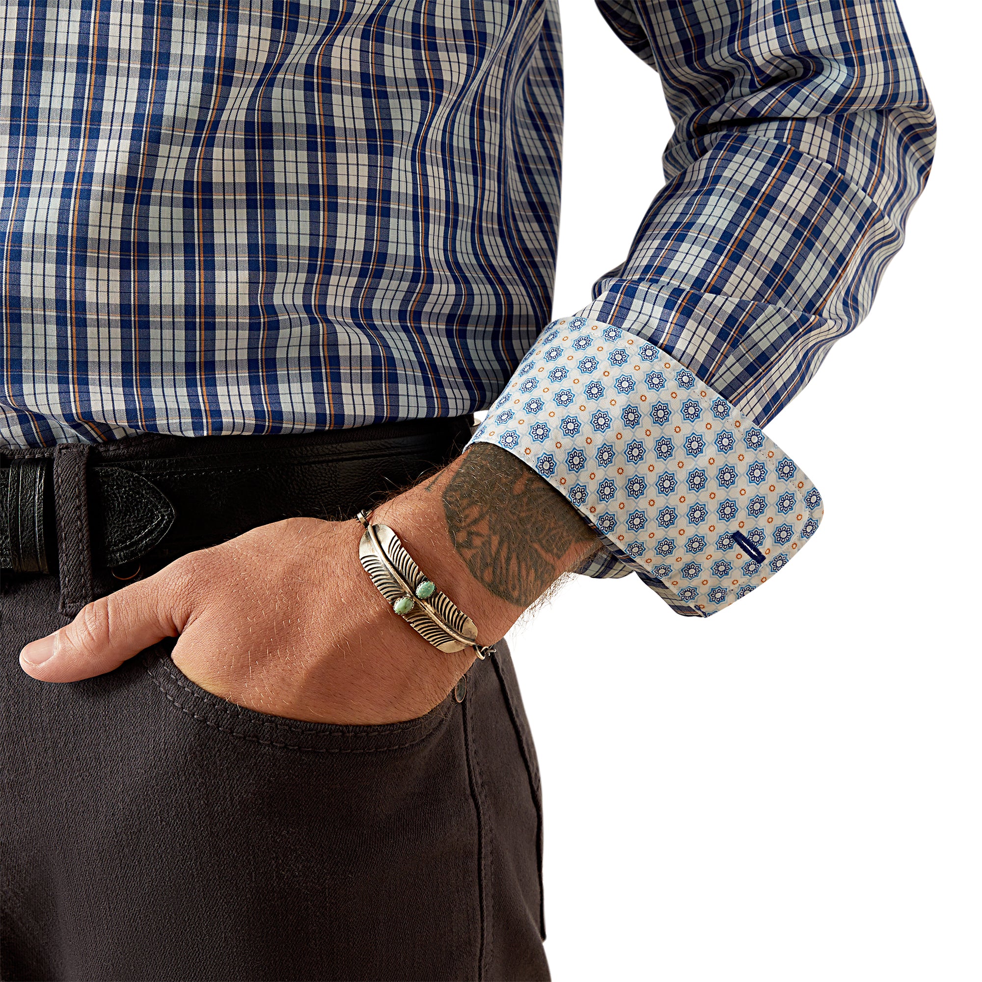 Ariat Men's Wrinkle Free Bronson Fitted L/S Western Shirt. Person wearing a blue and white checkered shirt with rolled-up sleeves, showing tattoos and jewelry.