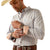 Ariat Men's Wrinkle Free Brendan Fitted L/S Western Shirt. Man wearing a plaid shirt with rolled-up sleeves, holding a bandage on his arm.