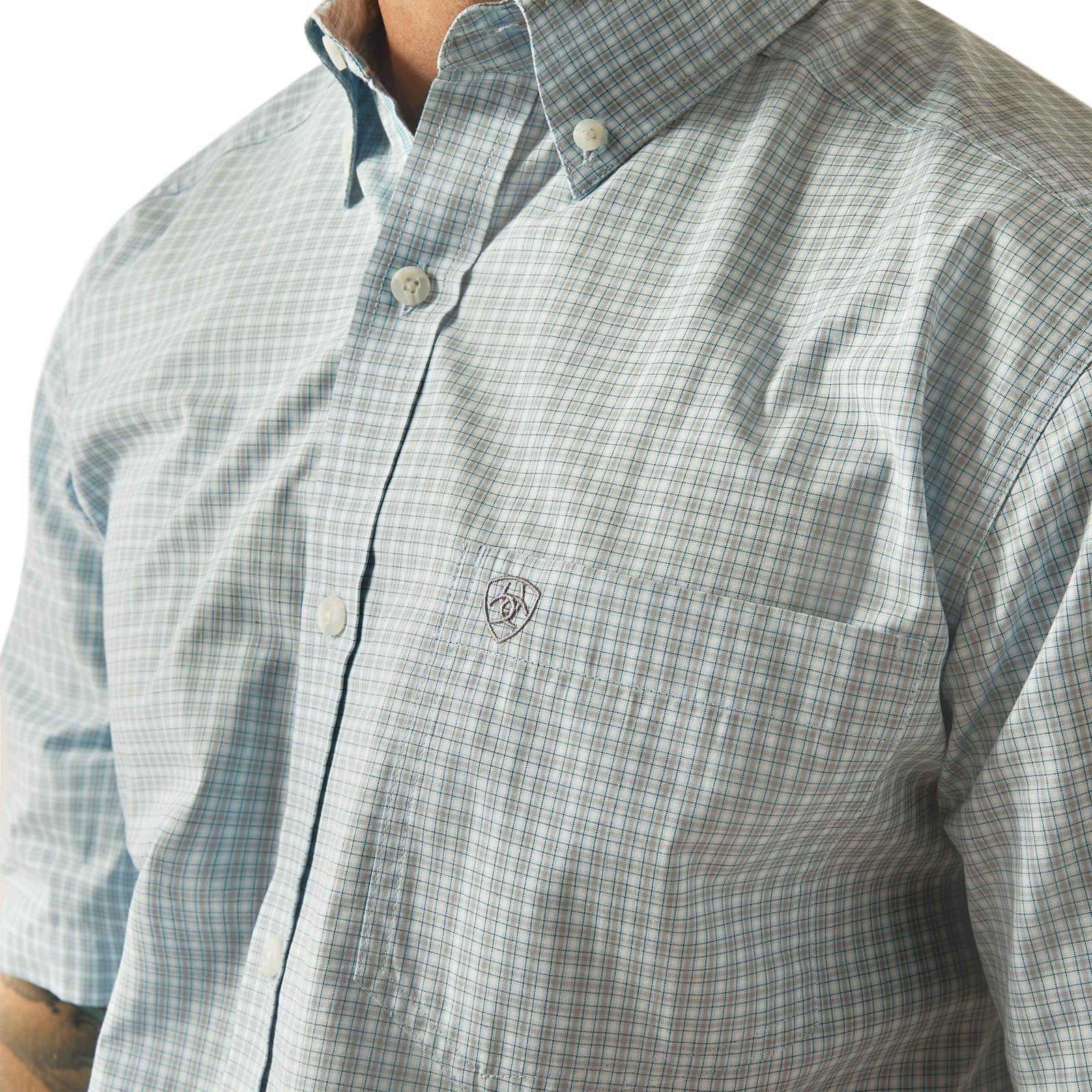 Ariat Men's Pro Series Glennie Classic Fit S/S Western Shirt. Close-up of a person wearing a plaid shirt with a brand logo on a white background