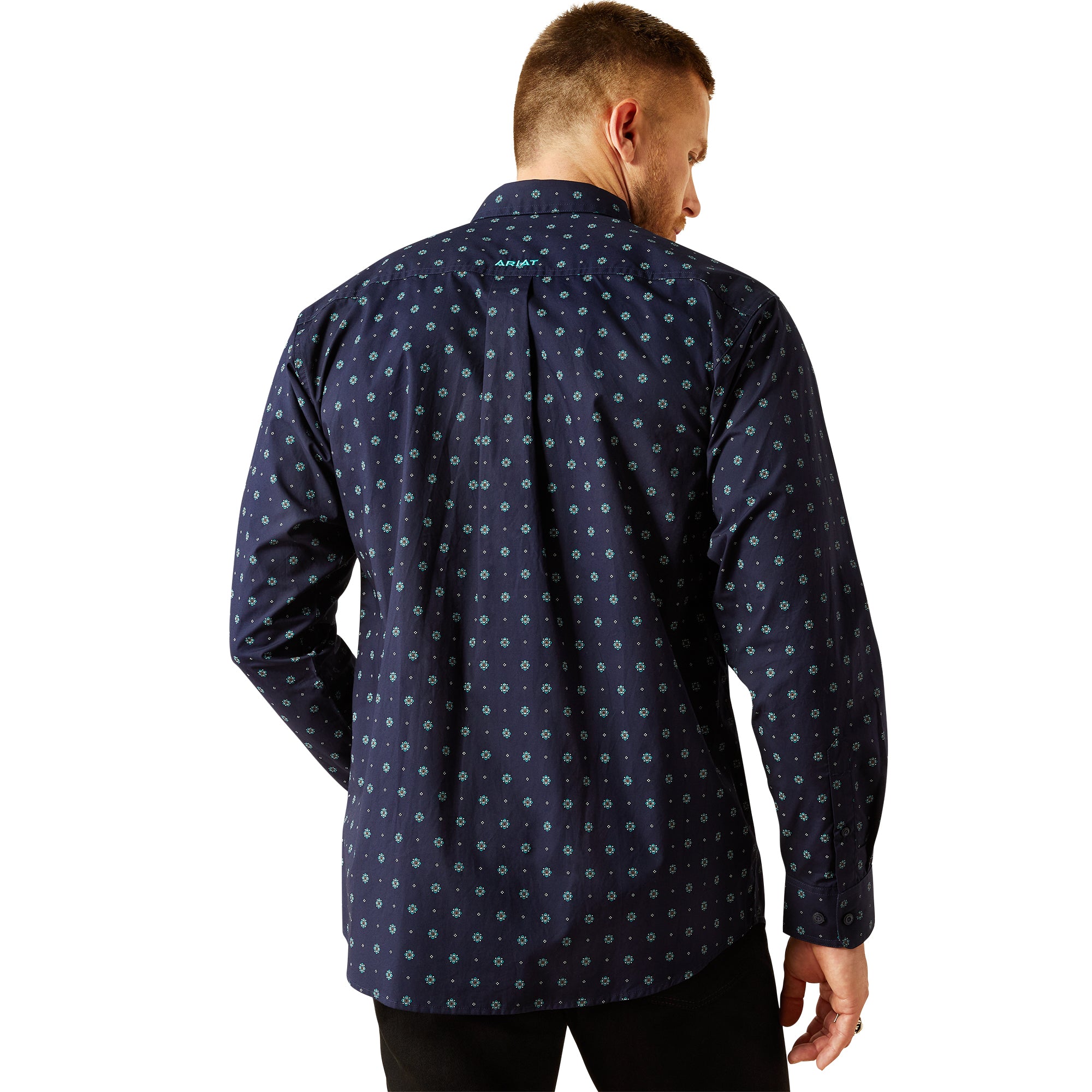 Ariat Men's Jacobi Classic Fit L/S Western Shirt. Man wearing a navy patterned shirt, black pants, and a beige cowboy hat on a white background