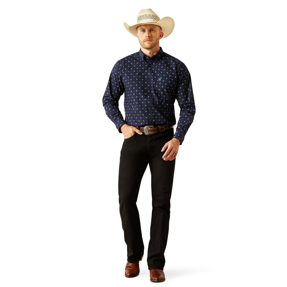Ariat Men's Jacobi Classic Fit L/S Western Shirt. Man wearing a navy patterned shirt, black pants, and a cowboy hat on a white background