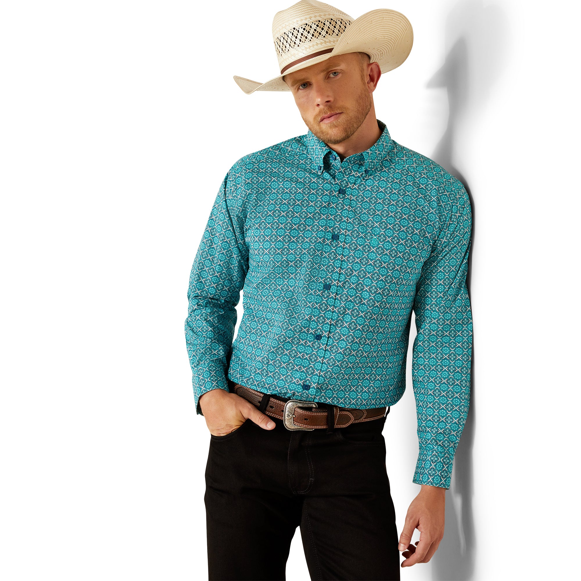 Ariat Men's Jordy Classic Fit L/S Western Shirt. Man wearing a turquoise patterned shirt and beige cowboy hat against a white background