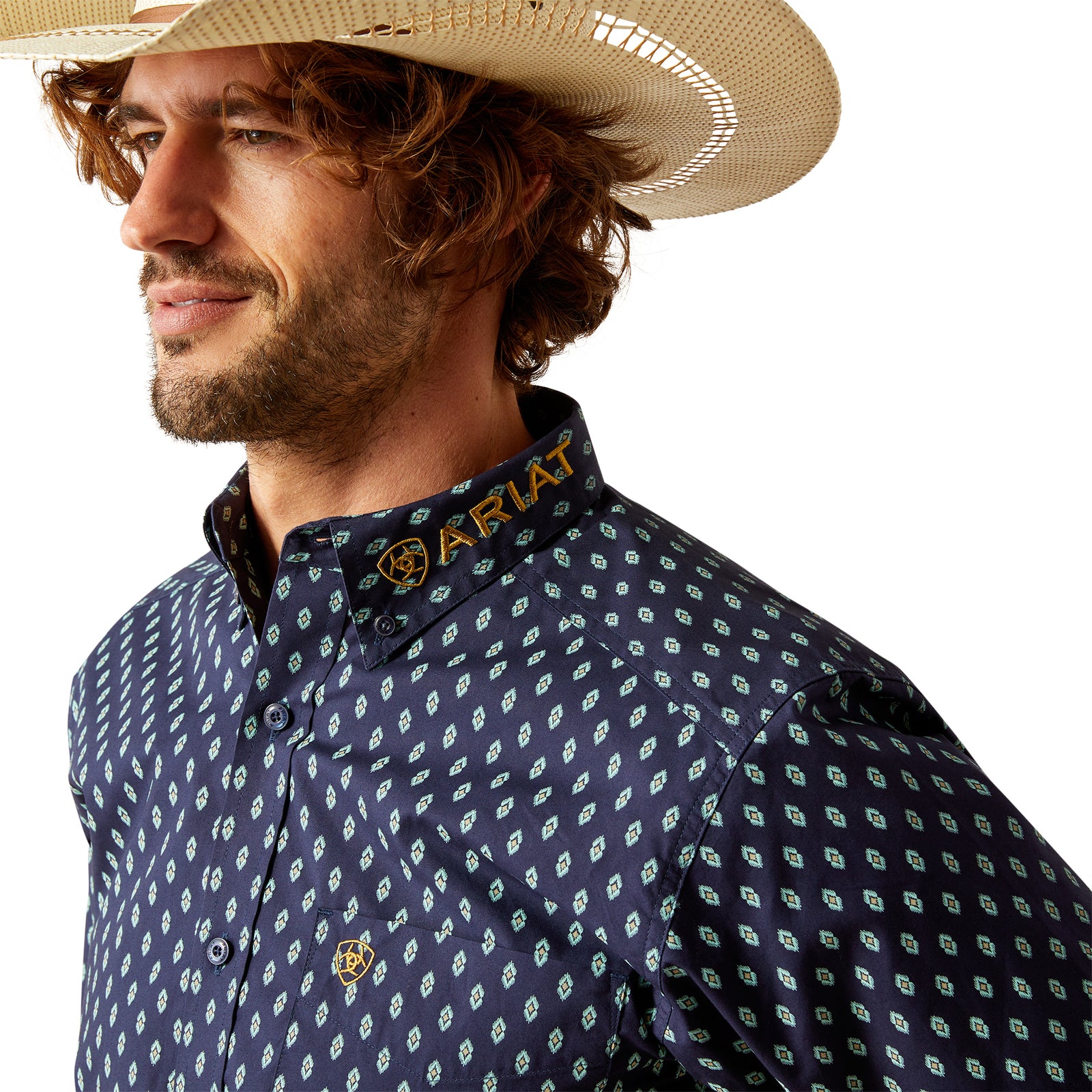 Ariat Men's Team Powell Fitted L/S Western Shirt. Man wearing a cowboy hat, patterned shirt, and jeans on a white background