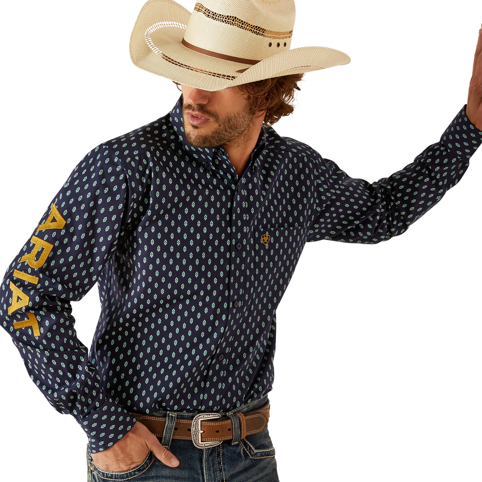 Ariat Men's Team Powell Fitted L/S Western Shirt. Man wearing a navy patterned shirt with 'Ariat' branding and a cowboy hat on a white background