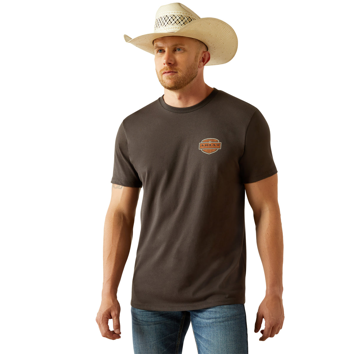 Ariat Men's Ol' Style Lockup T-Shirt. Man wearing a brown t-shirt with a logo and a cowboy hat on a white background