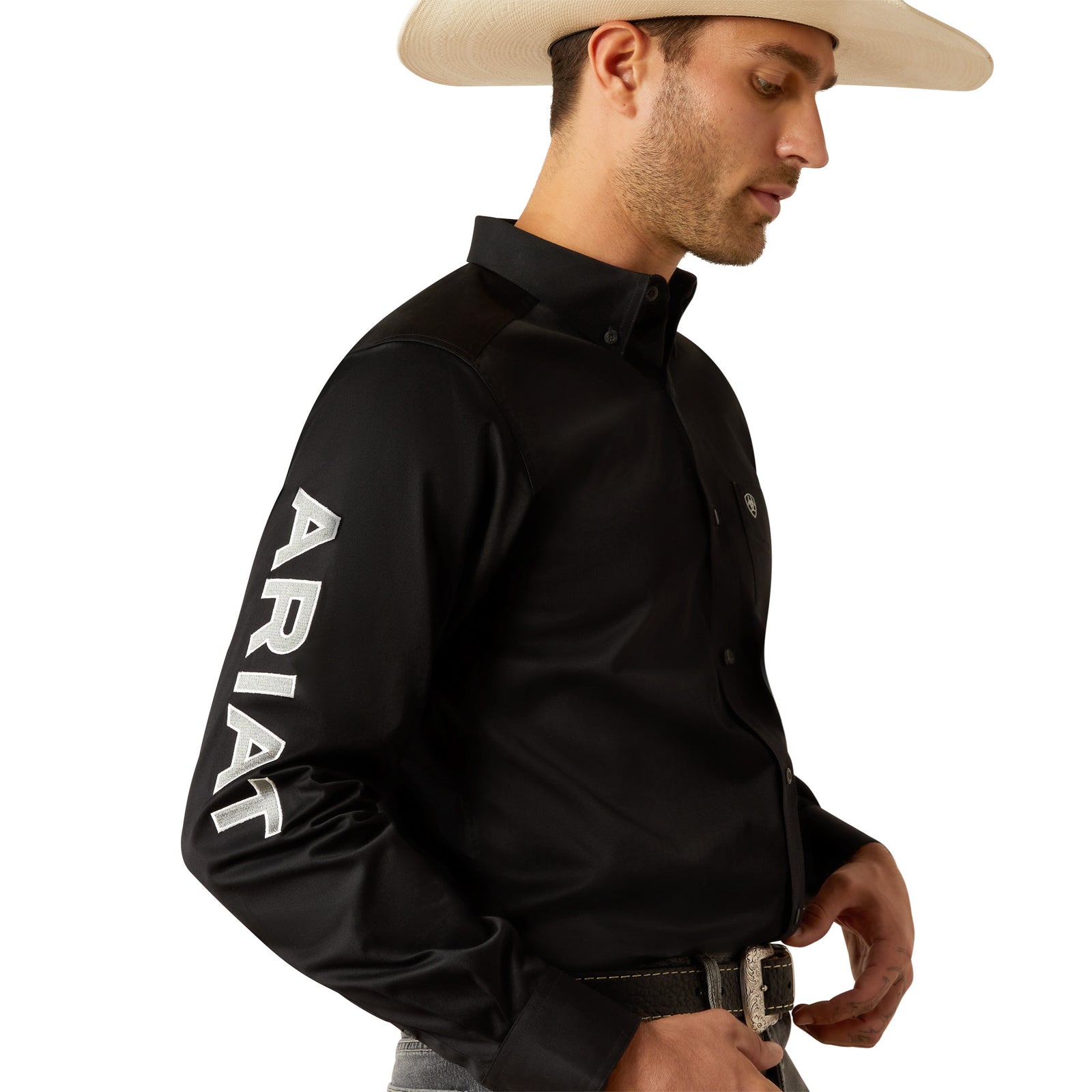 Ariat Men's Team Logo Twill L/S Western Shirt. Man wearing a black Ariat shirt with a white hat on a white background