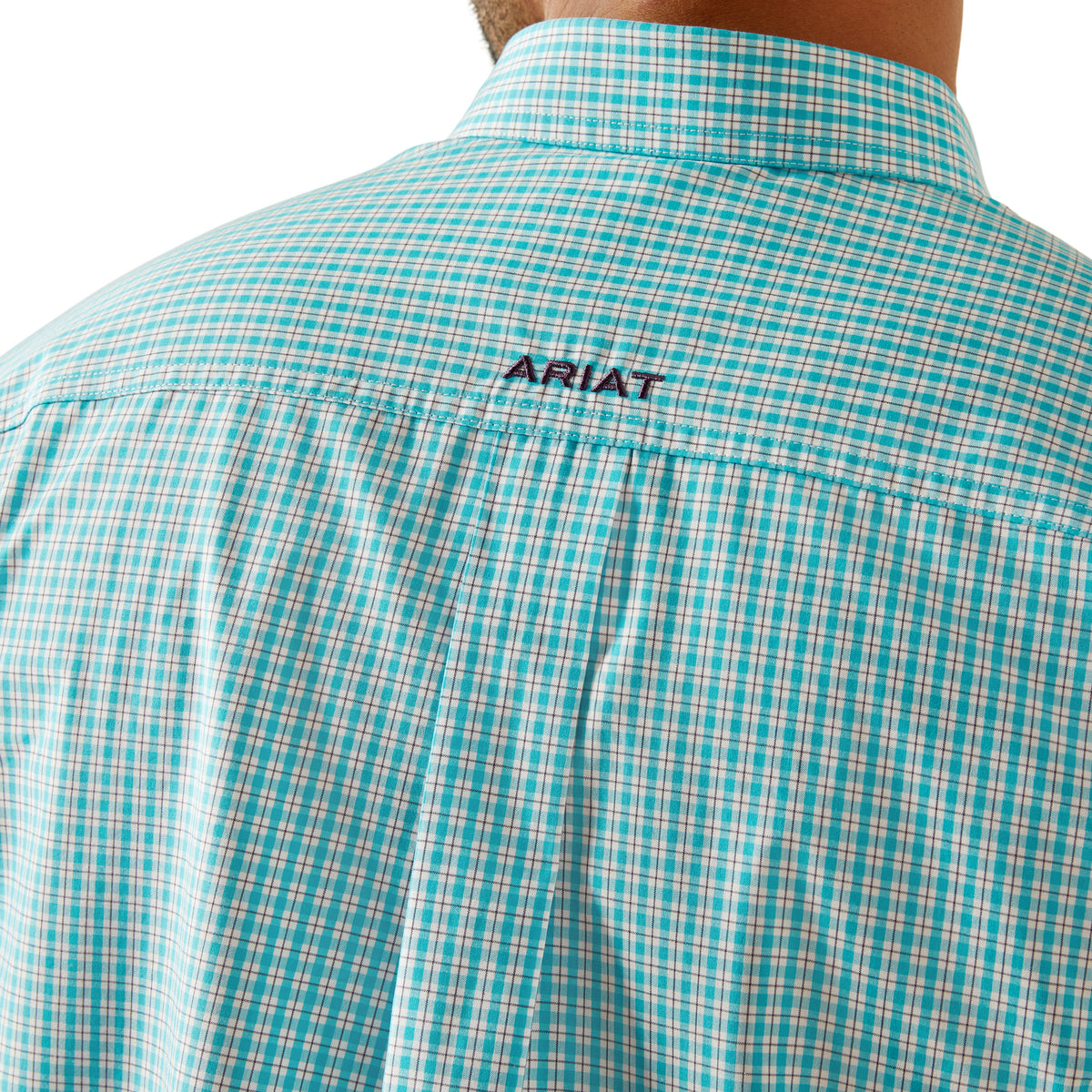 Ariat Men's Pro Series Wilmer L/S Western Shirt. Close-up of a teal and white checkered shirt with 'Ariat' branding on the back.