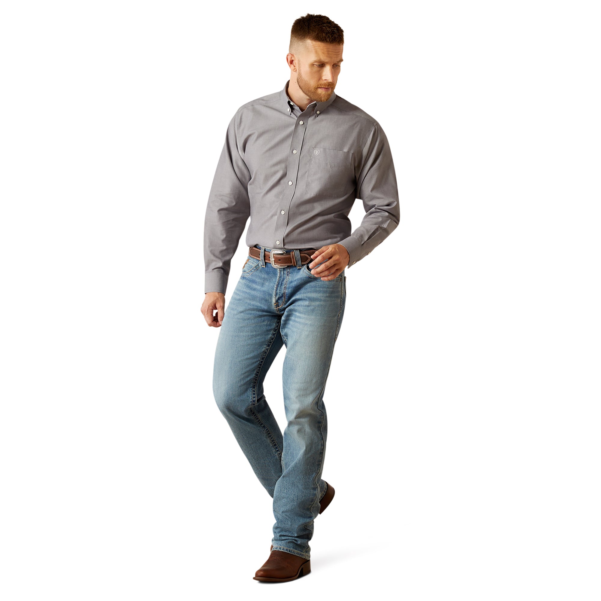 Ariat Men's Wrinkle Free Solid L/S Western Shirt. Man wearing a gray shirt and blue jeans on a white background
