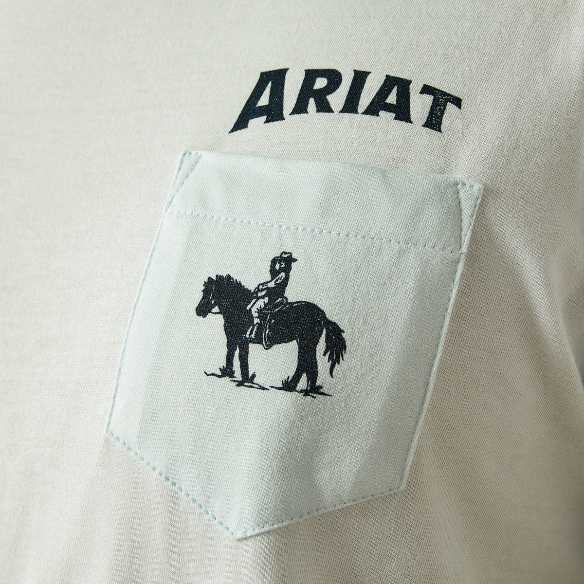 Ariat Men's Echo Valley T-Shirt. Close-up of a shirt with Ariat logo and horse and rider graphic on pocket.