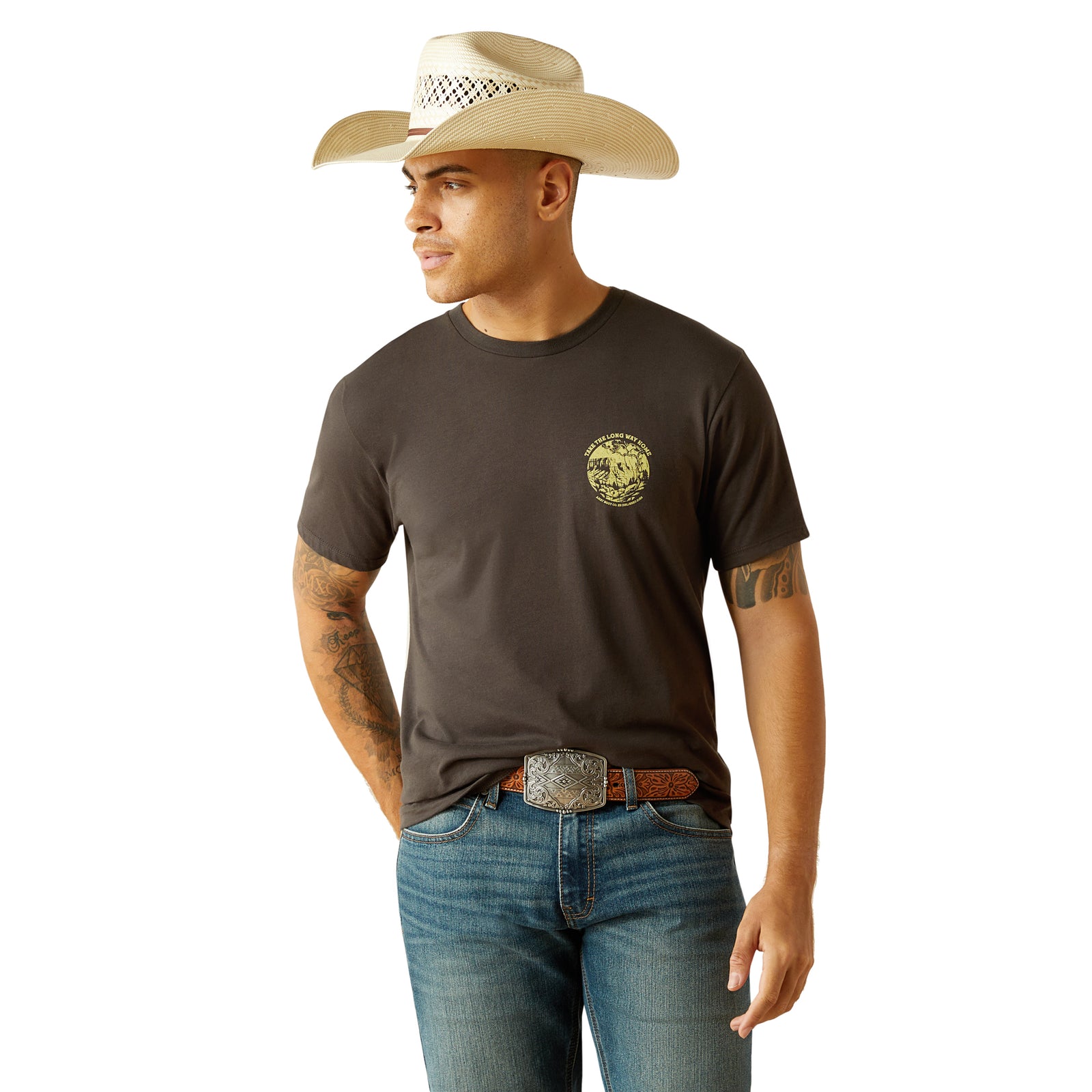 Ariat Men's Take the Long Way T-Shirt. Man wearing a brown t-shirt with a scenic graphic on the back, standing against a white background