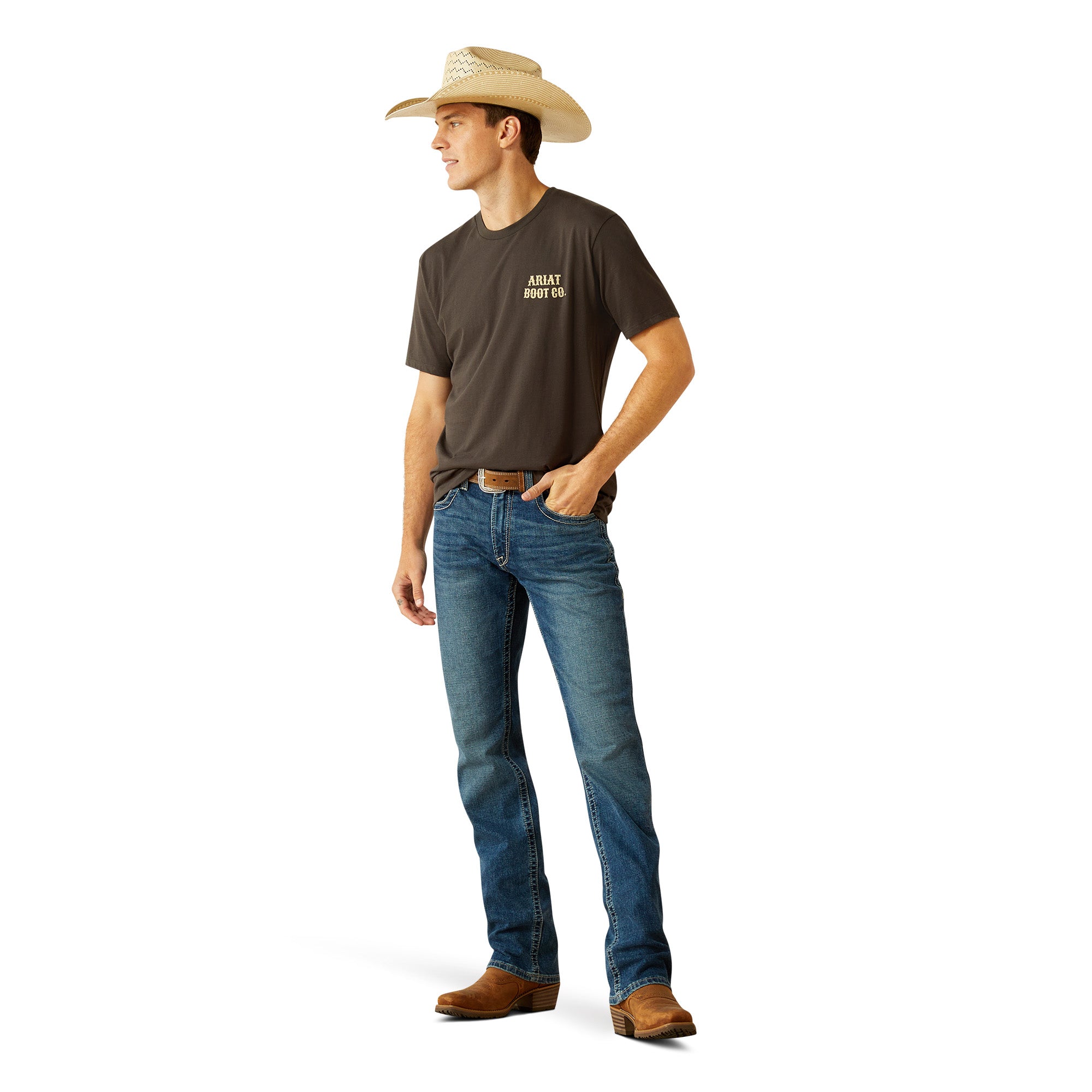Ariat Men's Cowboy Cocky T-Shirt. Man wearing a brown t-shirt with text, blue jeans, and a cowboy hat on a white background