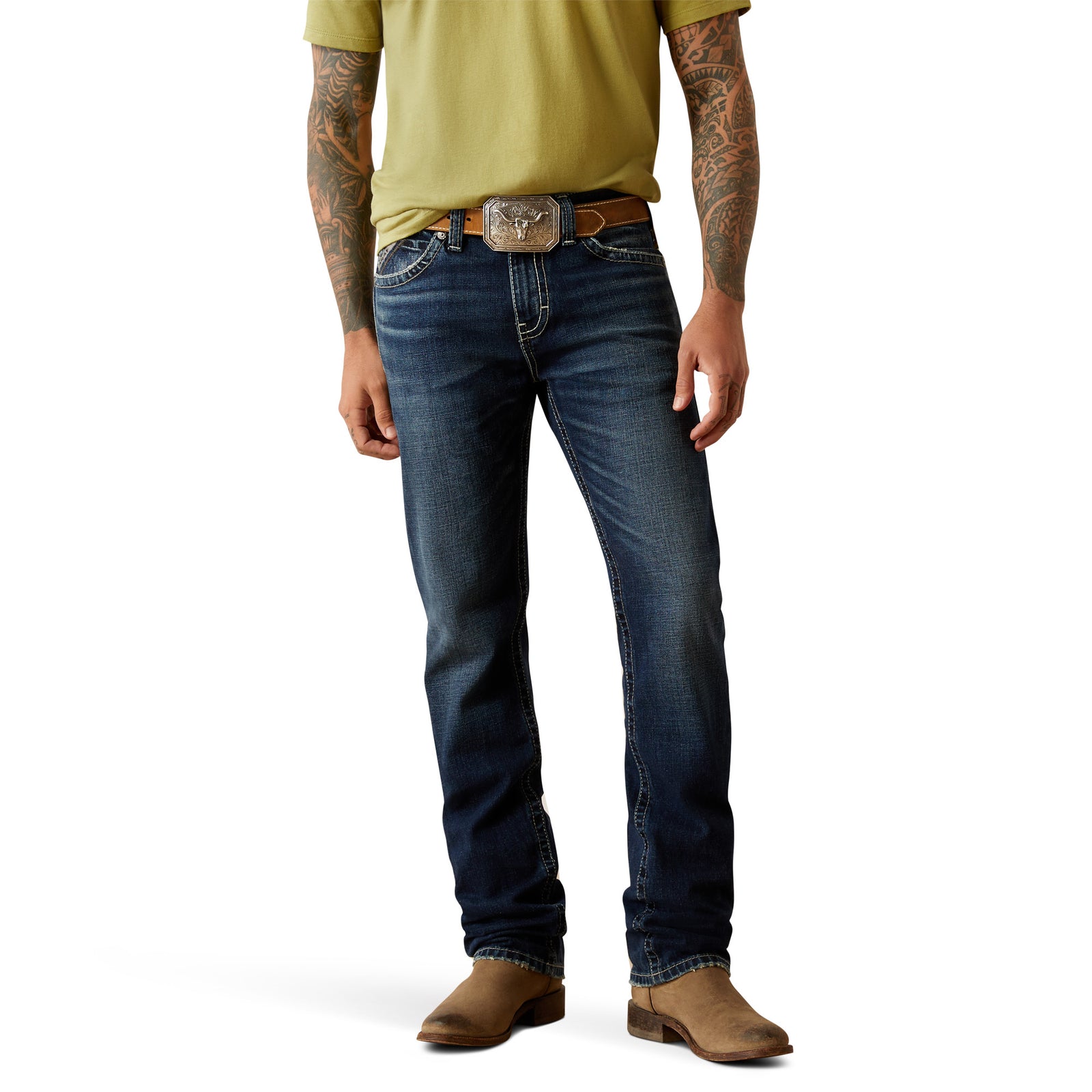 Ariat Men's M8 Modern Matthew Straight Leg JeanA man wearing a green t-shirt, blue jeans, and tan boots, with a belt buckle visible. 