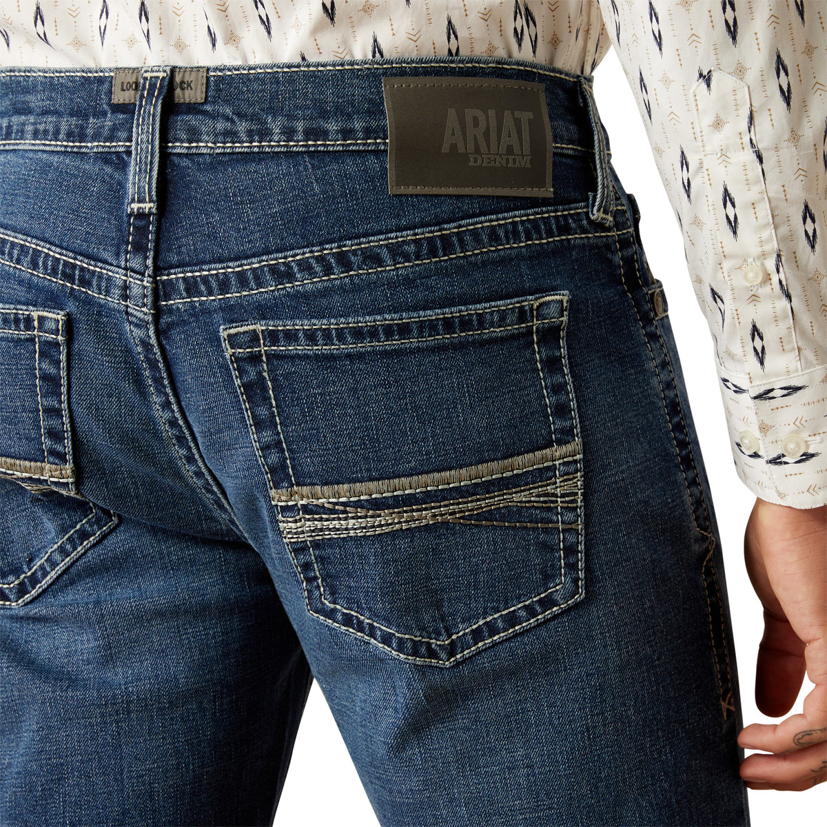 Ariat Men's M7 Wesley Slim Straight Leg Jean. Close-up of blue jeans with Ariat branding on a white background