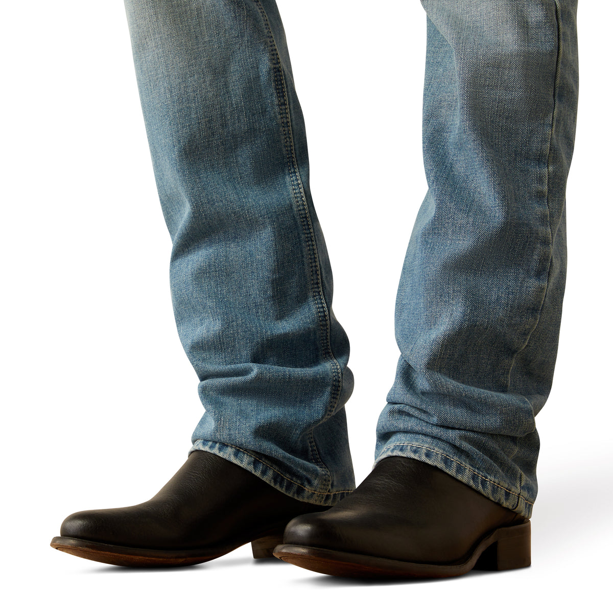Ariat Men's M7 Ethan Slim Straight Leg Jean. Blue jeans and black boots on a white background