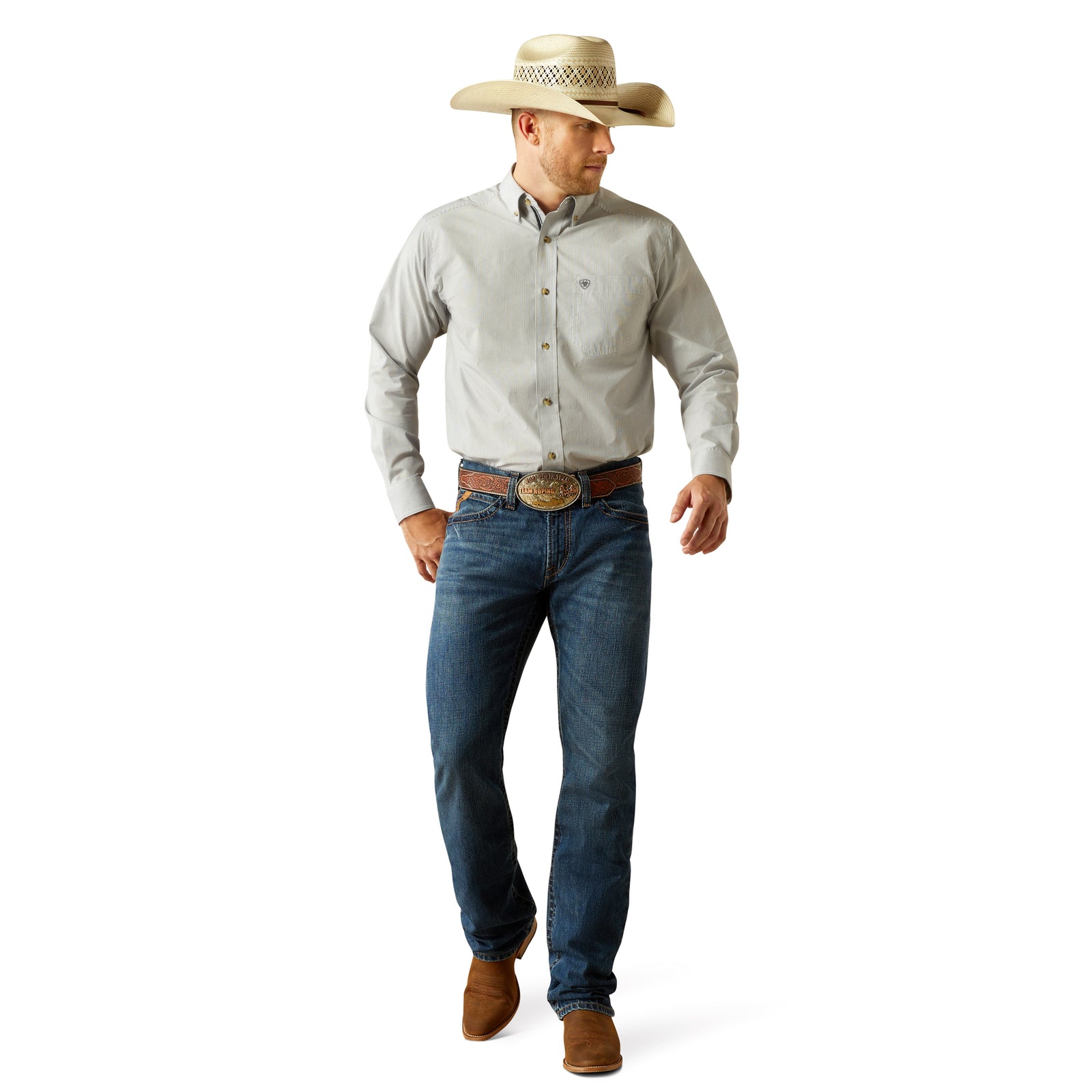 Ariat Men's M4 Norwich Relaxed Fit Jean. Man wearing a light gray shirt, blue jeans, and a cowboy hat on a white background