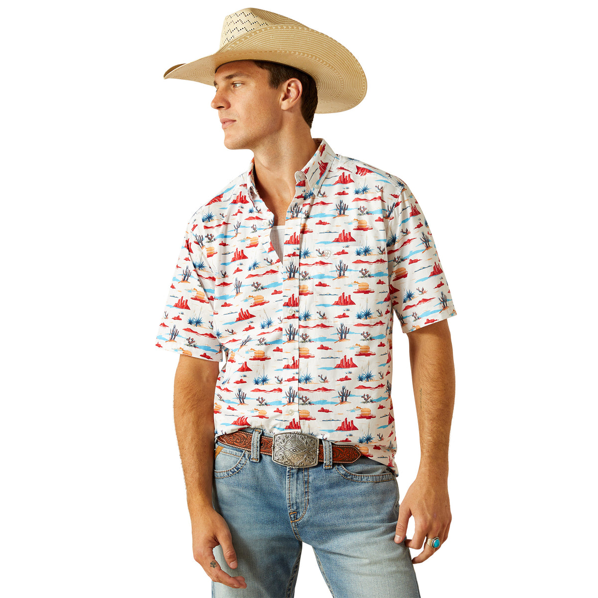 Ariat Men&#39;s Scout S/S Western Shirt. Man wearing a patterned shirt, jeans, and a cowboy hat on a white background