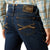 Ariat Men's M8 Modern Shawn Straight Leg Jean. Person wearing blue jeans with an Ariat denim label on a white background