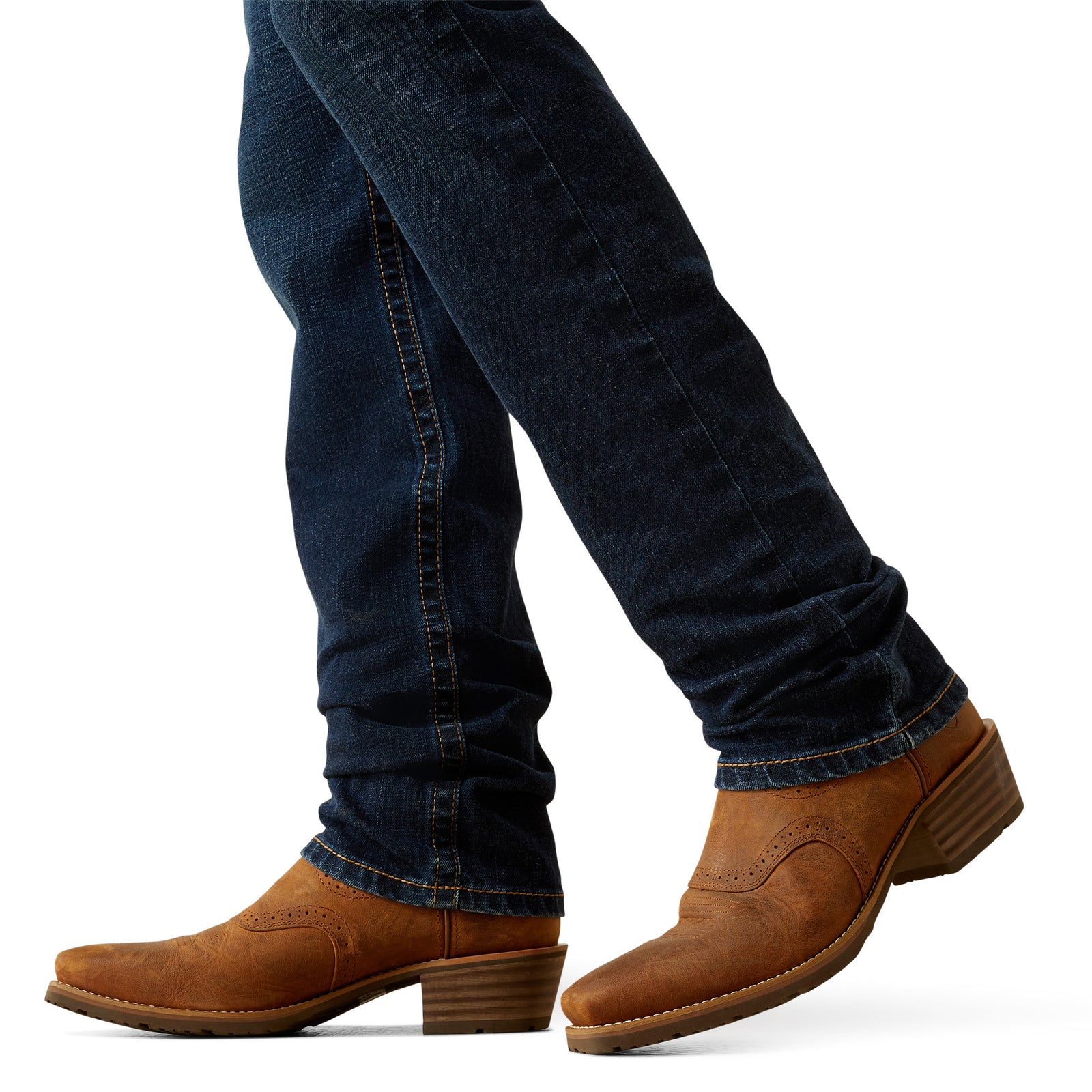 Ariat Men's M8 Modern Shawn Straight Leg Jean. Brown leather shoes worn with blue jeans on a white background