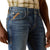 Ariat Men's M7 Travis Straight Leg Jeans. Close-up of blue jeans with a brand logo on the pocket against a white background