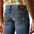 Ariat Men's M7 Travis Straight Leg Jeans. Close-up of blue jeans with Ariat logo on a white background