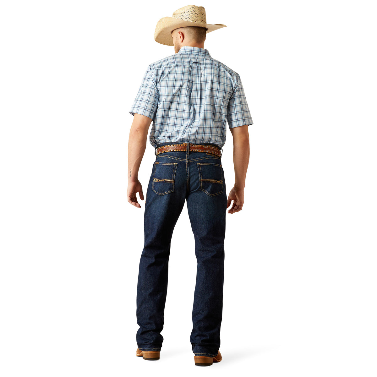 Ariat Men's M4 Otis Boot Cut Jean. Man wearing a plaid shirt, jeans, and a cowboy hat on a white background