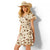 Ariat Women's Stellar Dress. Woman wearing a patterned dress and straw hat on a white background