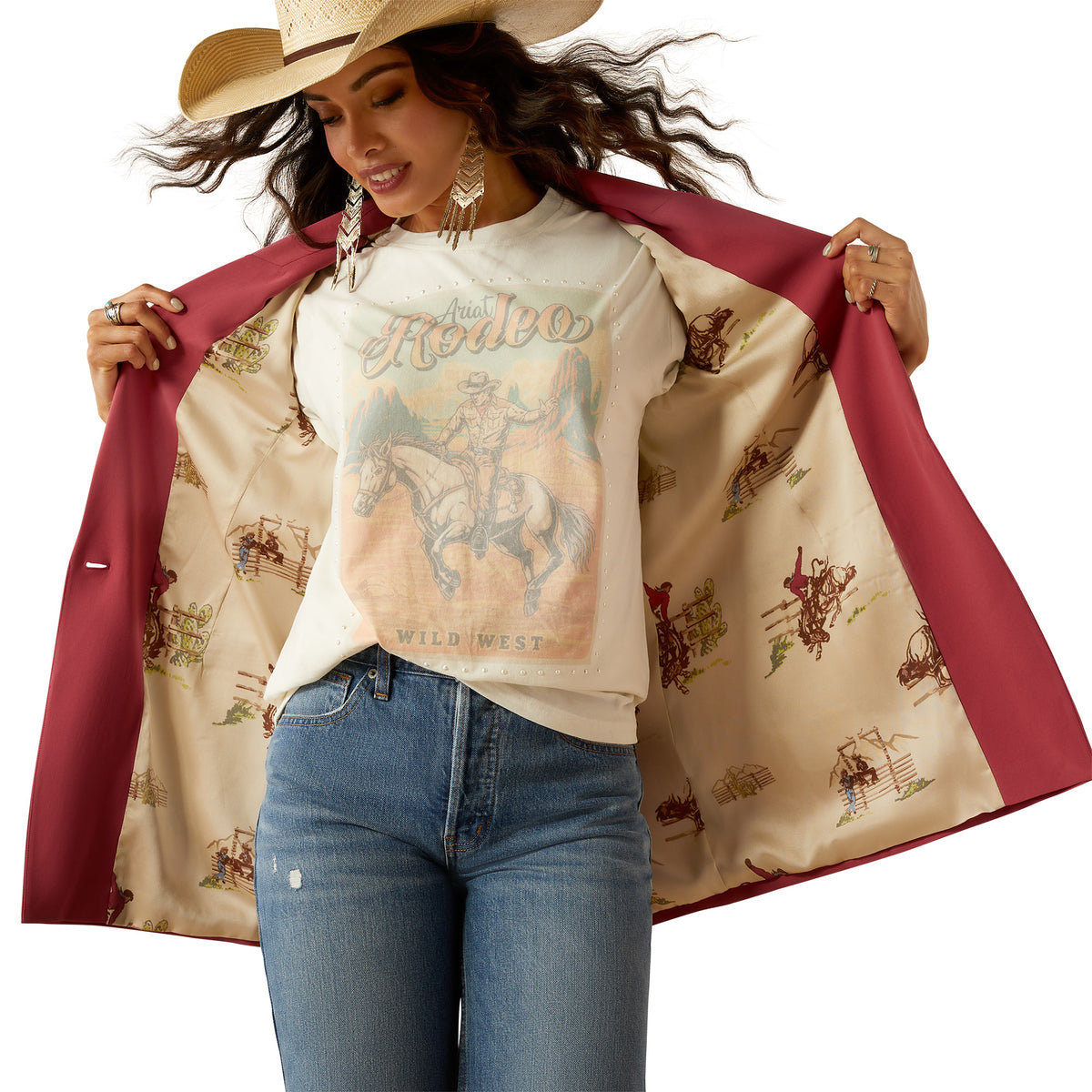 Ariat Women's Ella Blazer. Woman wearing a cowboy hat and a patterned jacket over a graphic t-shirt with a horse design.