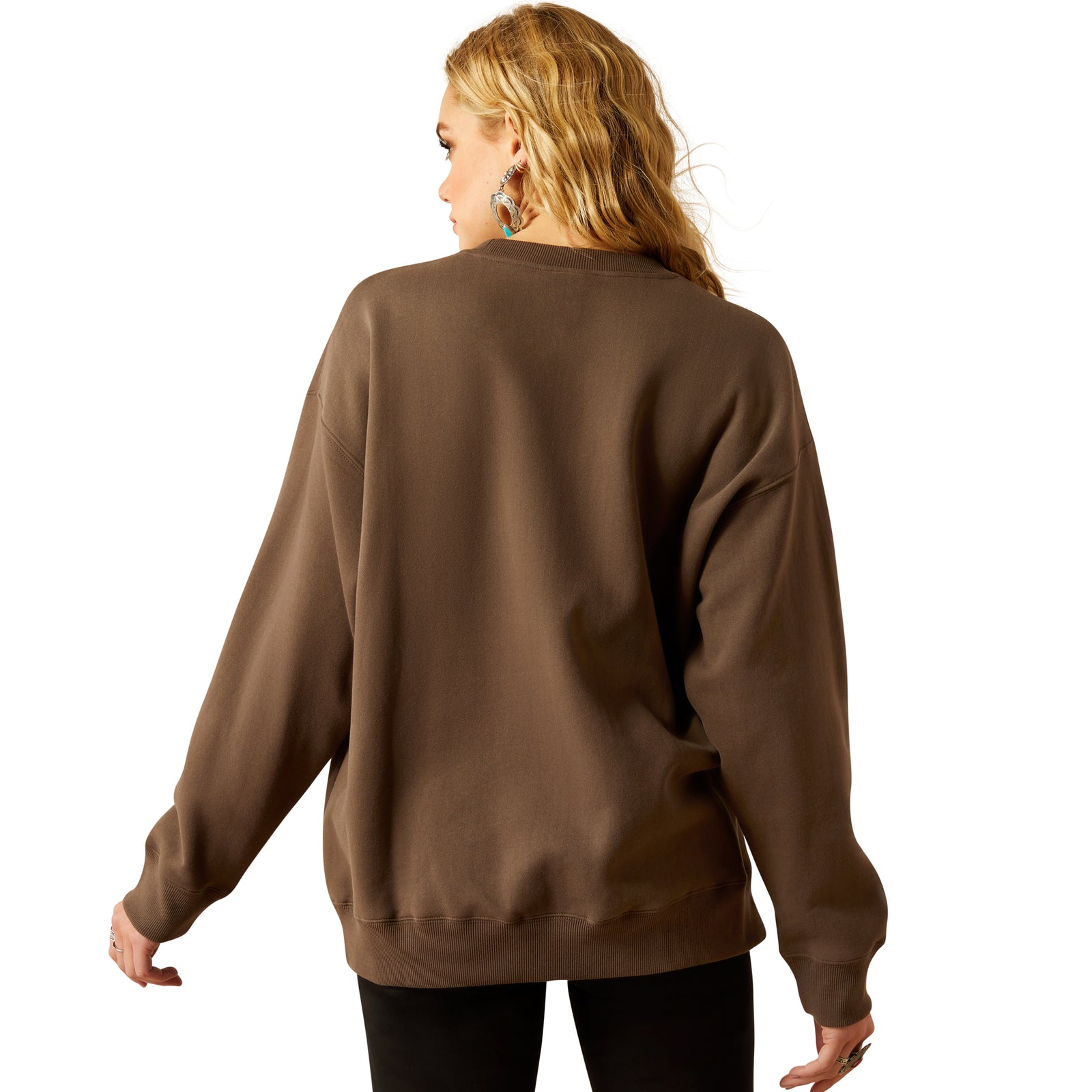 Ariat Women's Oversized Crew Sweatshirt. Woman wearing a brown sweatshirt with 'Ariat' branding on a white background