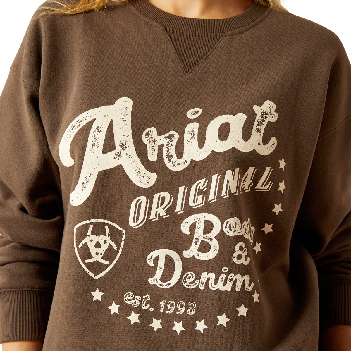 Ariat Women's Oversized Crew Sweatshirt. Brown sweatshirt with 'Ariat Original Boot & Denim' text and logo on a white background