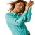 Ariat Women's Kirby Pro L/S Western Shirt. Woman wearing a turquoise shirt and blue jeans on a white background