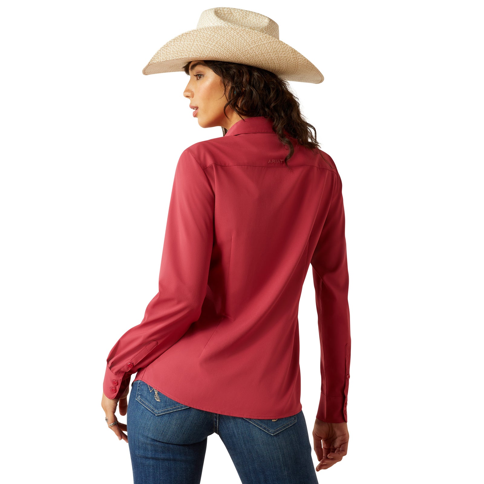 Ariat Women's Kirby Pro L/S Western Shirt. Woman wearing a red shirt, blue jeans, and a cowboy hat on a white background