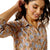 Ariat Women's Homestyle Button Up L/S Western Shirt. Woman wearing a floral patterned shirt with a plain background