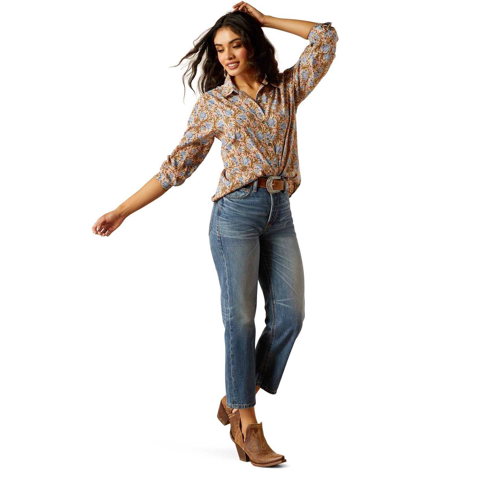 Ariat Women's Homestyle Button Up L/S Western Shirt. Woman wearing a patterned blouse and jeans on a white background