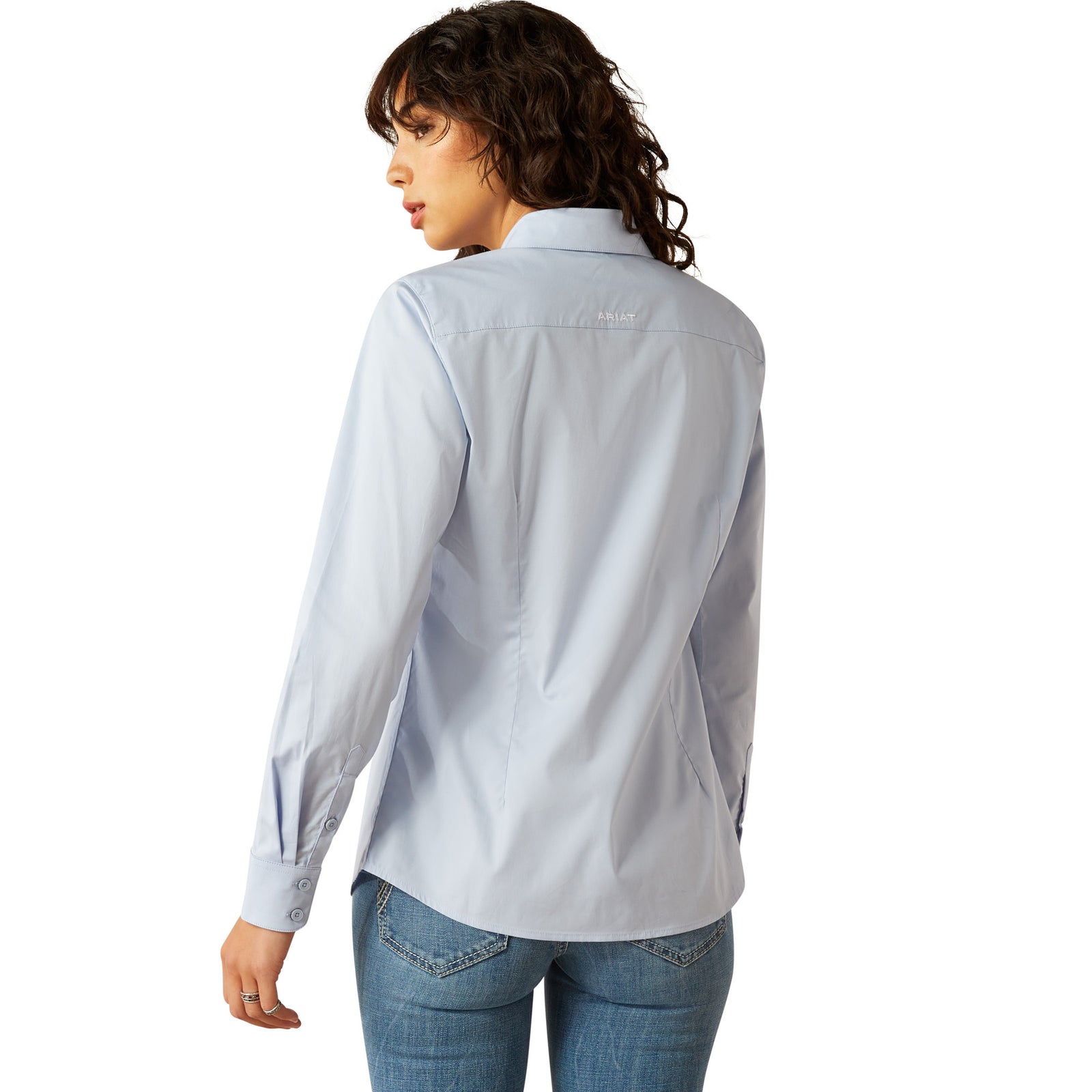 Ariat Women's Wrinkle Resistant Team Kirby Western Shirt. Person wearing a light blue shirt with a brand logo on a white background