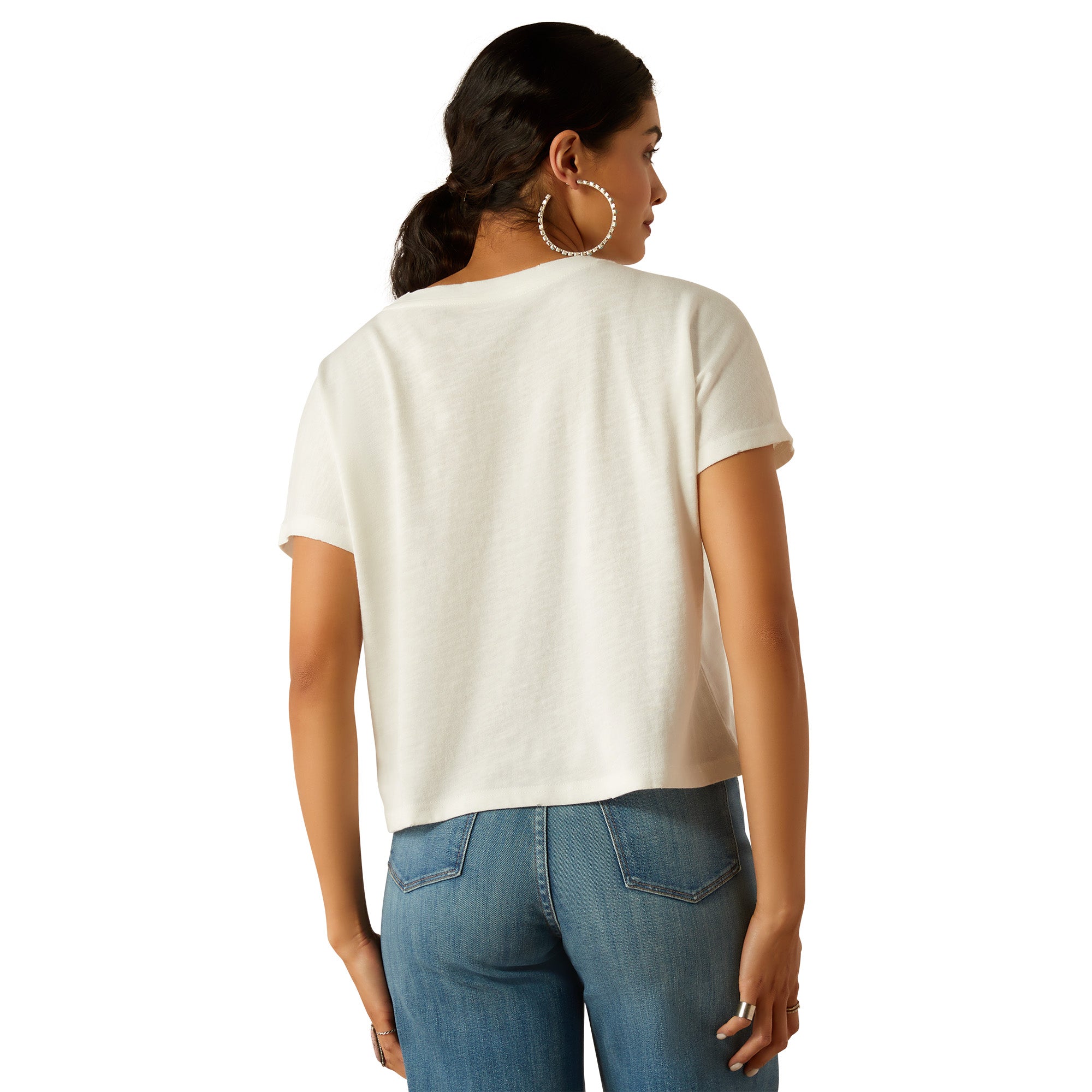 Ariat Women's Cowboy T-Shirt. Woman wearing a white t-shirt and blue jeans on a white background