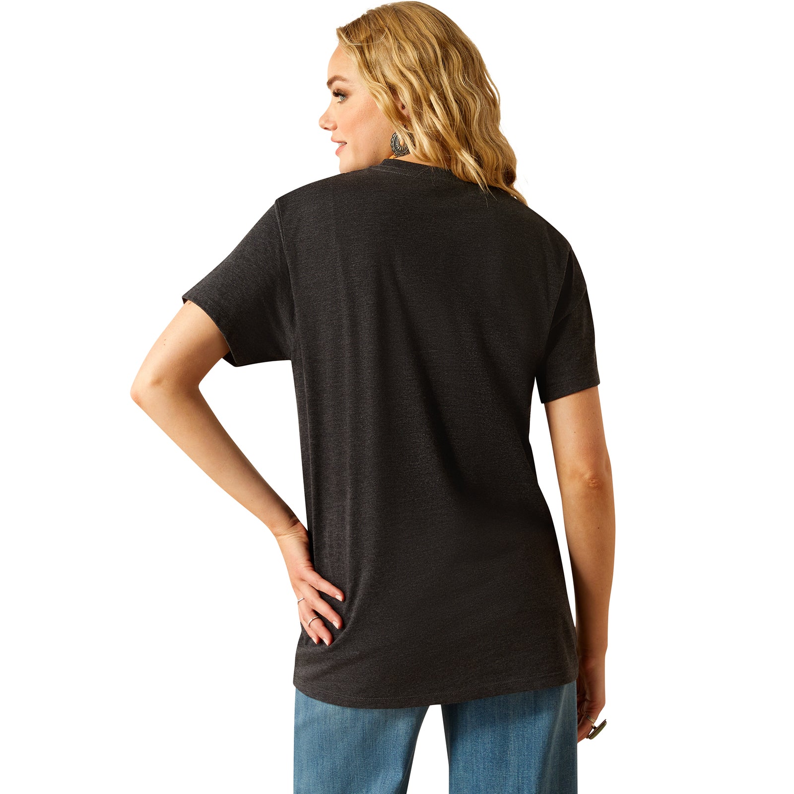 Ariat Women's Postcard T-Shirt. Person wearing a black t-shirt and blue jeans on a white background