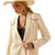 Ariat Women's Parton Blazer. Woman wearing a beige blazer and cowboy hat on a white background