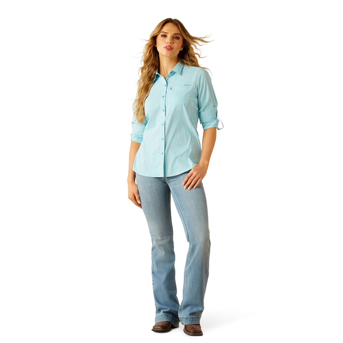 Ariat Women's VentTEK L/S Western Shirt. Woman wearing a light blue shirt and jeans on a white background