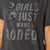 Àriat Women's Rodeo Girls T-Shirt. T-shirt with 'Girls Just Want to Rodeo' text and Ariat logo on a dark gray background
