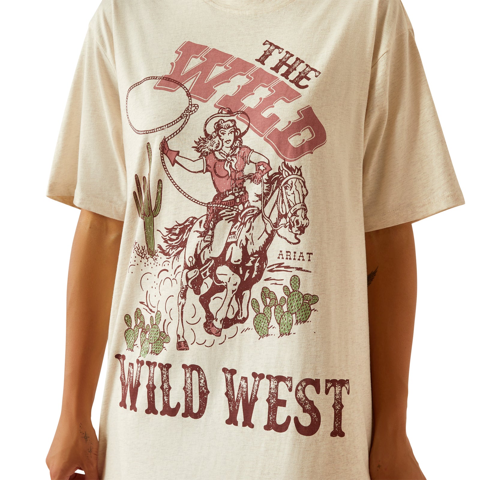 Ariat Women's Wild Cowgirl T-Shirt Dress. Woman wearing a beige t-shirt with a graphic design and a cowboy hat on a white background