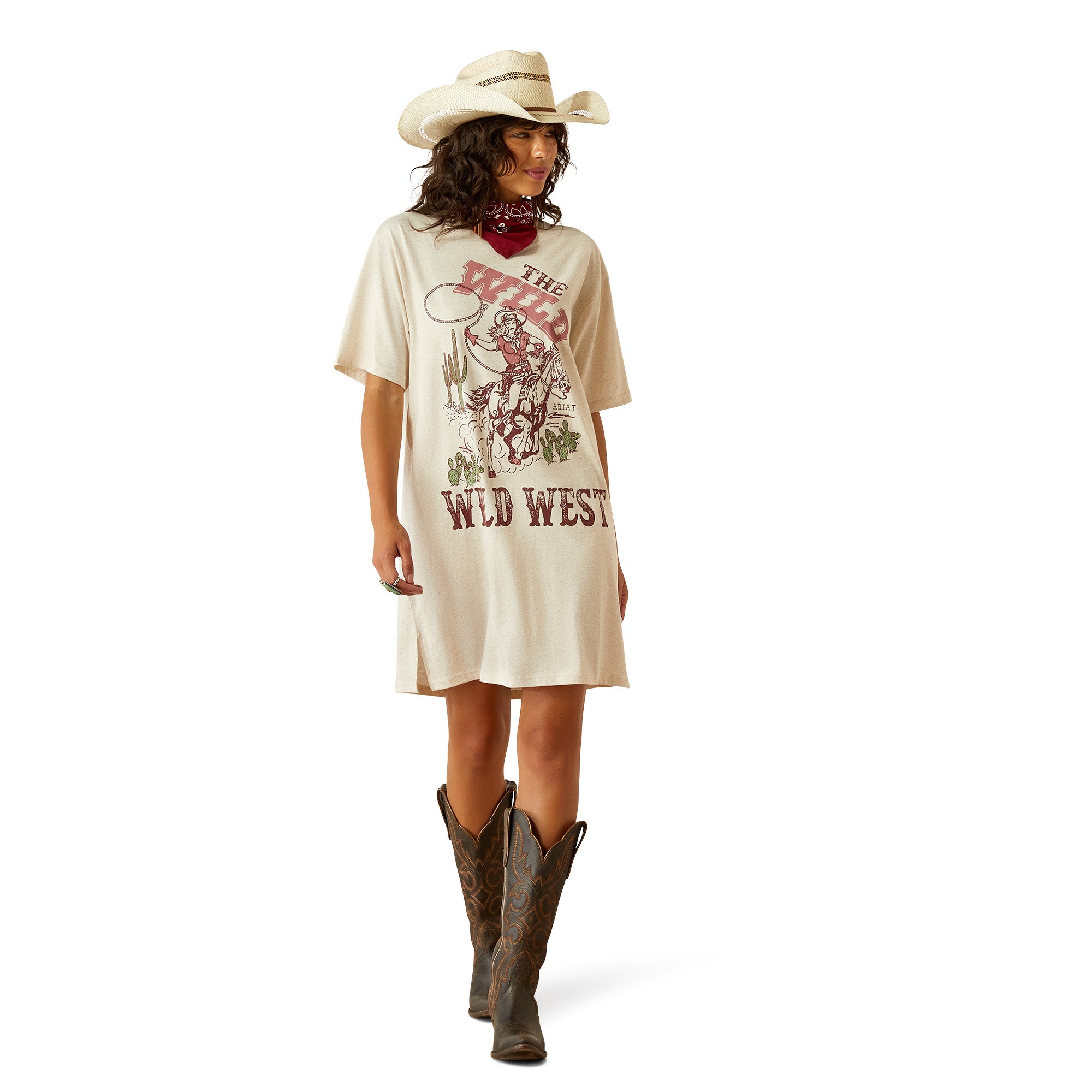 Ariat Women's Wild Cowgirl T-Shirt Dress. Woman wearing a 'Wild West' themed dress and cowboy hat on a white background