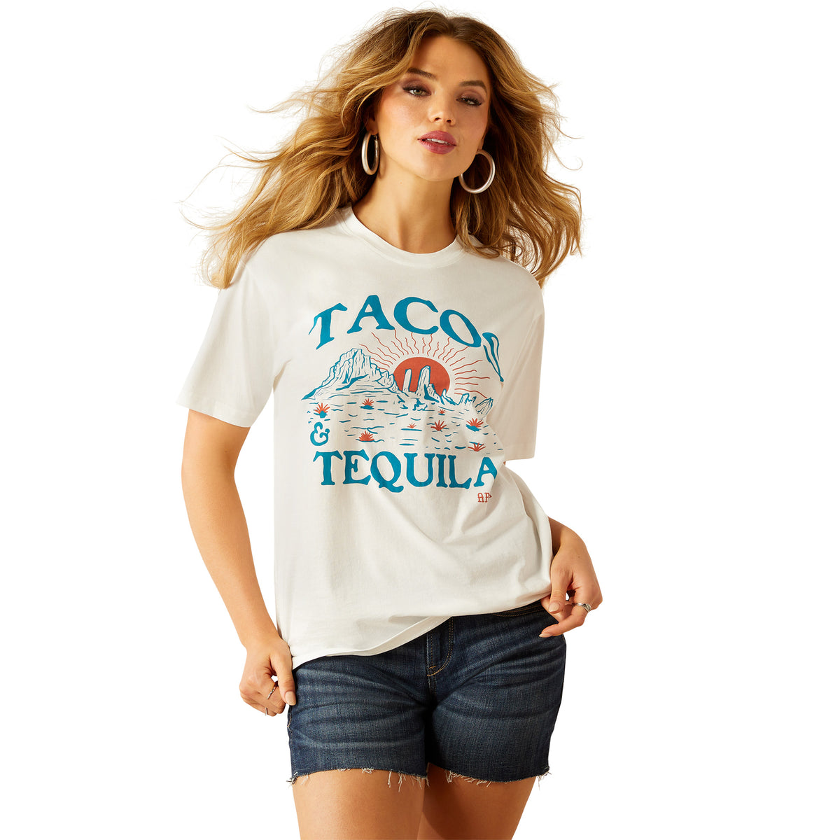 Ariat Women&#39;s Tacos and Tequila T-Shirt. Woman wearing a white t-shirt with &#39;Taco &amp; Tequila&#39; graphic design on a white background