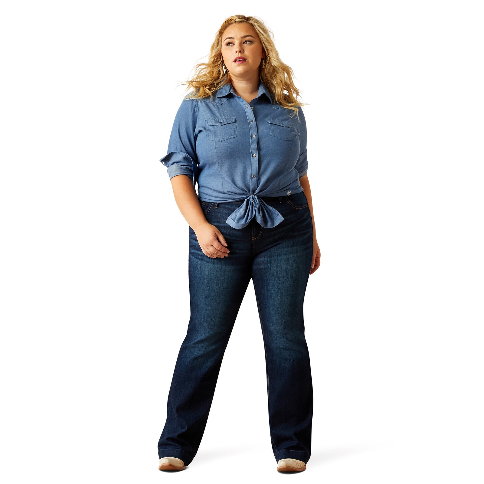 Woman wearing a blue denim shirt and jeans on a white background