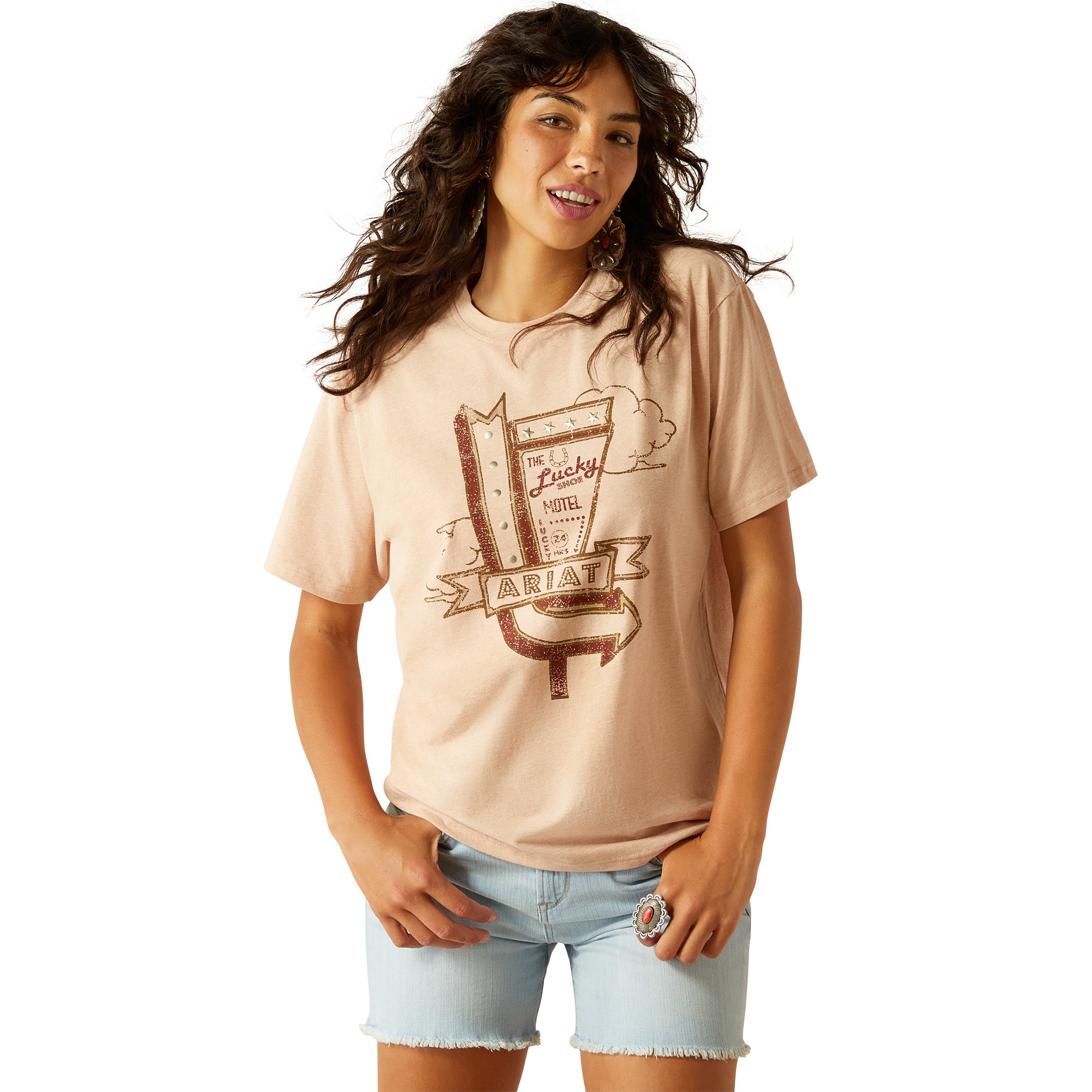 Ariat Women's Roadside T-Shirt. Woman wearing a beige t-shirt with graphic design on a white background