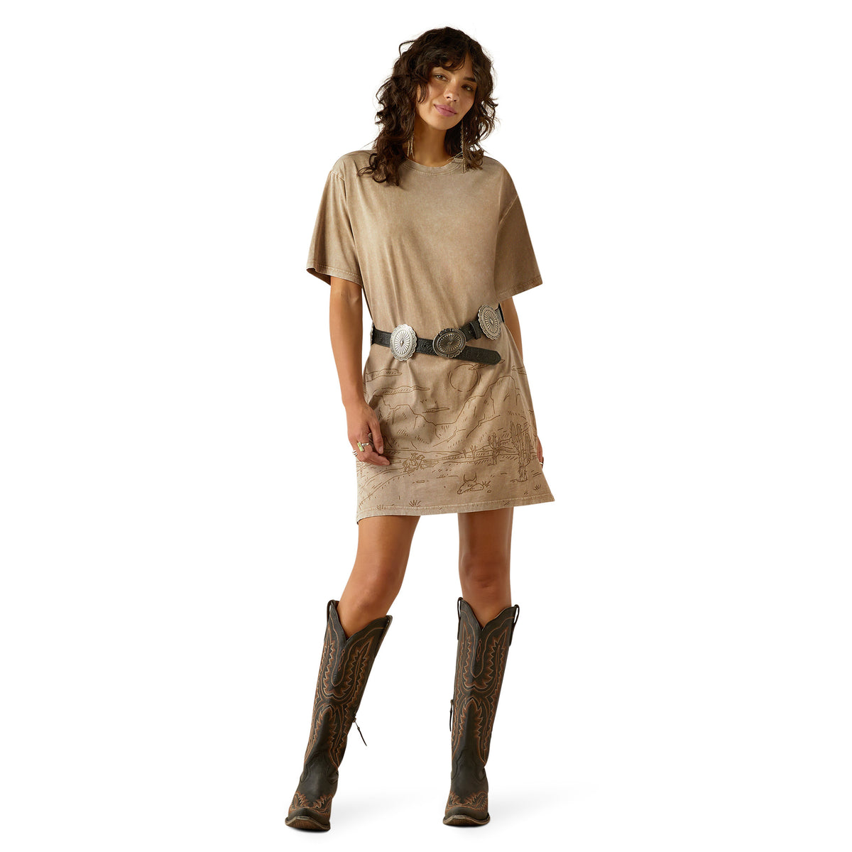 Ariat Women's Road Trip T-Shirt Dress. Woman wearing a beige dress and brown boots on a white background