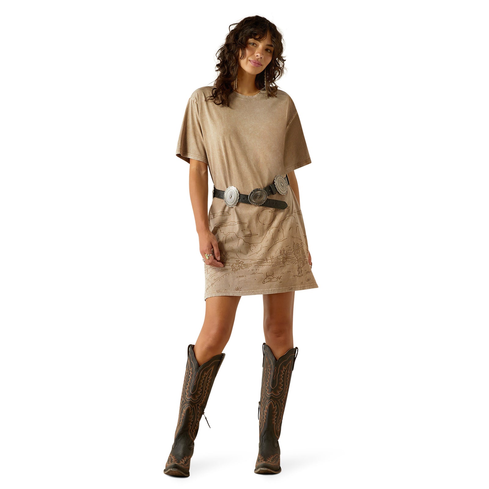 Ariat Women's Road Trip T-Shirt Dress. Woman wearing a beige dress and brown boots on a white background