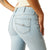 Ariat Women's June Perfect Rise Flare Jean. Light blue jeans worn by a person on a white background