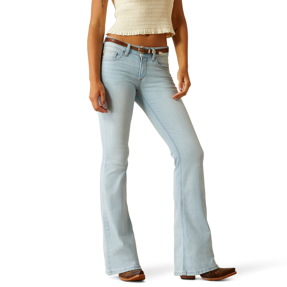 Ariat Women&#39;s June Perfect Rise Flare Jean. Light blue jeans worn by a person on a white background